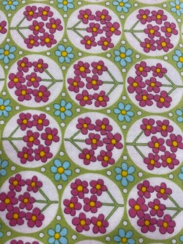 Molly Flannel - Bunches of pink flowers in white circles, blue flowers on green background